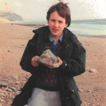 A young James and his ammonite find on his first trip to Charmouth Dorset in the 1990s
